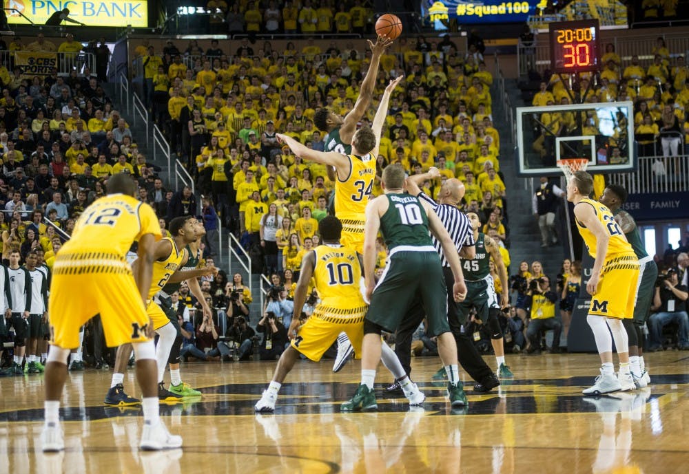 Freshmen forward Deyonta Davis and Michigan forward 	Mark Donnal tip off the game against Michigan at Crisler Center in Ann Arbor on Feb. 6, 2016.  The Spartans defeated the Wolverines 89-73.