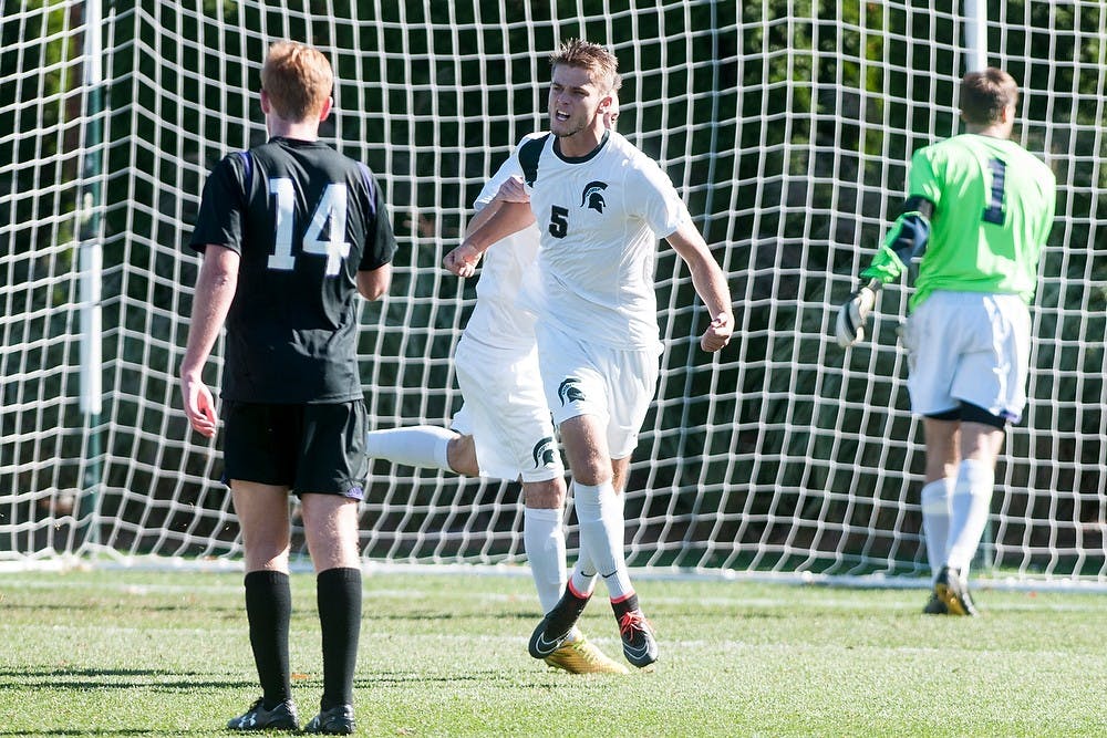 <p>Junior defender Zach Carroll celebrates after scoring a goal during the game against Northwestern on Oct. 26, 2014, at DeMartin Stadium at Old College Field. The game ended with a draw of 1-1. Aerika Williams/The State News</p>