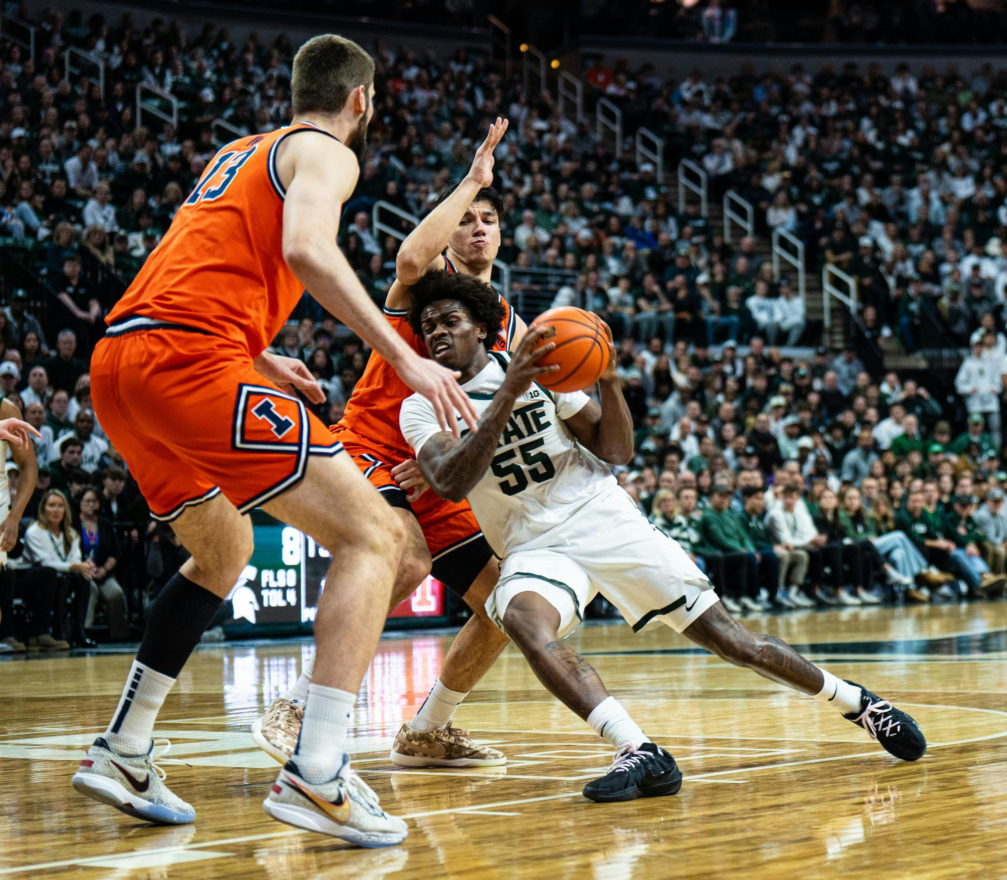 MSU Jr. forward, Coen Carr (55) lays into an Illinois guard during the MSU versus Illinois matchup at the Breslin Center in East Lansing, Michigan on Feb. 7, 2026.