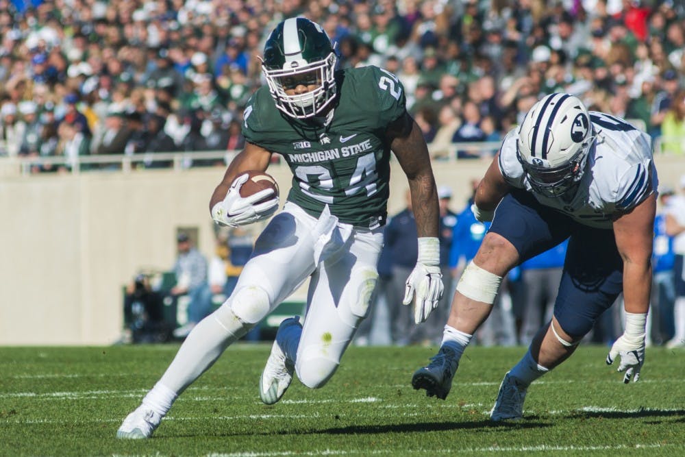 Junior running back Gerald Holmes (24) runs the ball up the field during the first quarter of the game against Brigham Young University on Oct. 8, 2016 at Spartan Stadium.  The Spartans were defeated by the Cougars, 31-14. 