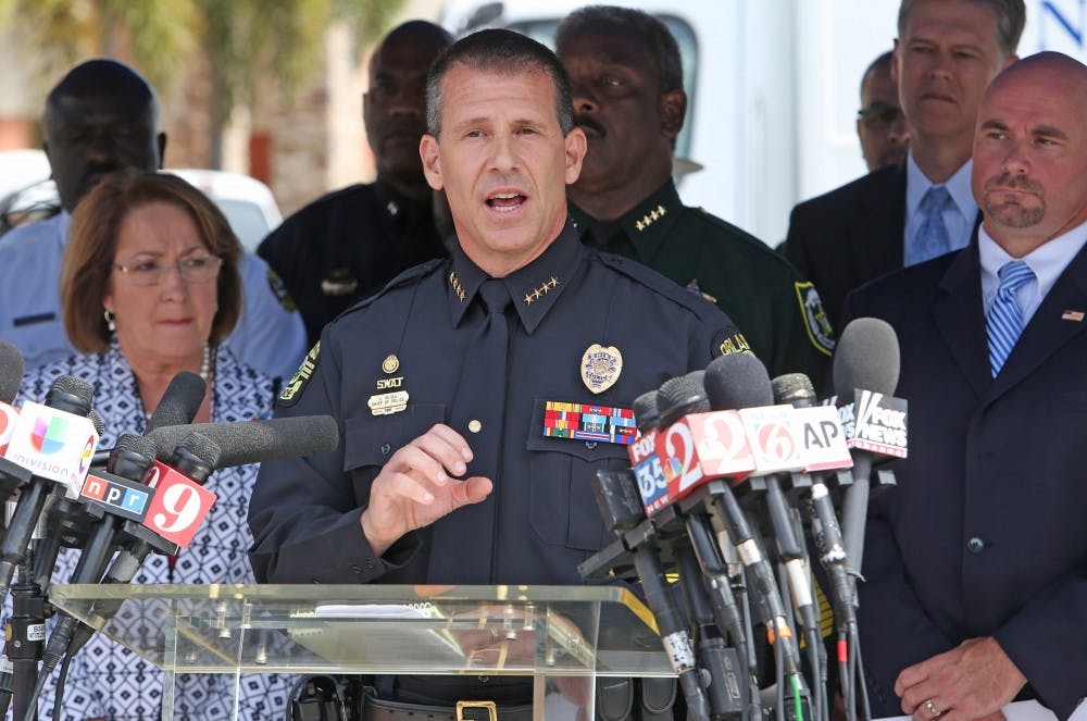 Chief John Mina, Orlando Police, center, talks to the media during a press briefing on Monday, June 20, 2016 near the Pulse Nightclub shooting scene in Orlando.   (Red Huber/Orlando Sentinel/TNS) 
