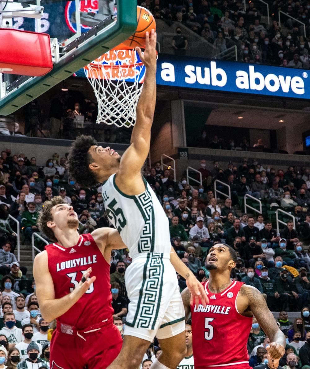 <p>Junior forward Malik Hall (25) shoots the ball in the basket backward during the first half. The Spartans beat the Cardinals, 73-64, to win the B1G/ACC Challenge on Dec. 1, 2021. </p>