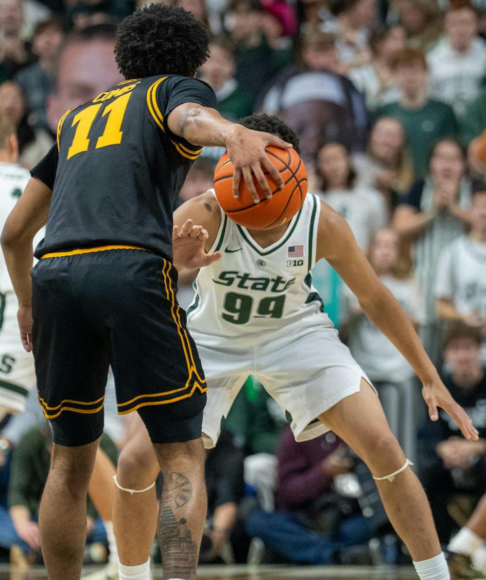 <p>Sophomore guard Divine Ugochukwu (99) defends an Iowa player during their matchup at the Breslin Center on Dec. 2, 2025.</p>