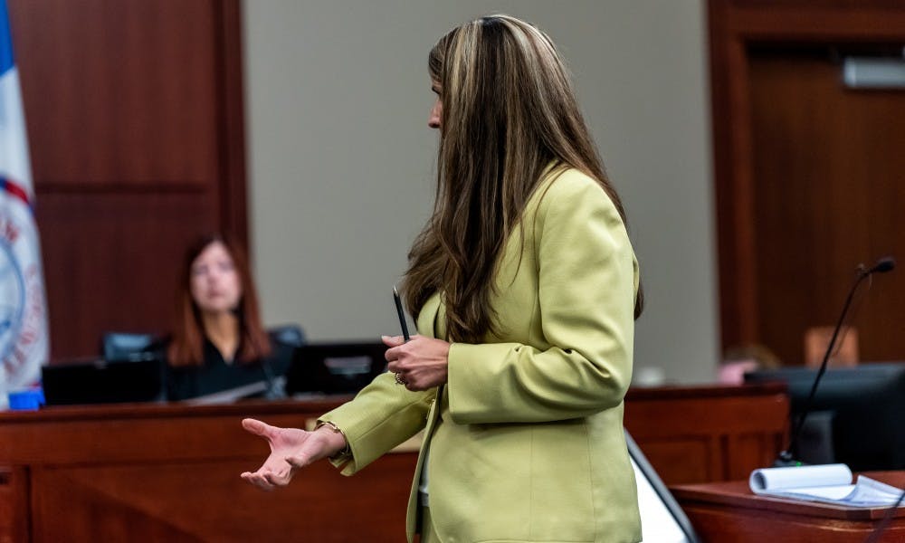 <p>Assistant Attorney General Danielle Hagaman-Clark demonstrates a grabbing gesture to Dr. Nicole Eastman, asking her if this was the way that William Strampel grabbed her buttock during a fundraising event in 2010. The trial of the MSU College of Osteopathic Medicine’s former Dean Dr. William Strampel for charges of sexual assault and sexual misconduct continued at the Ingham County Circuit Court on June 4, 2019.</p>