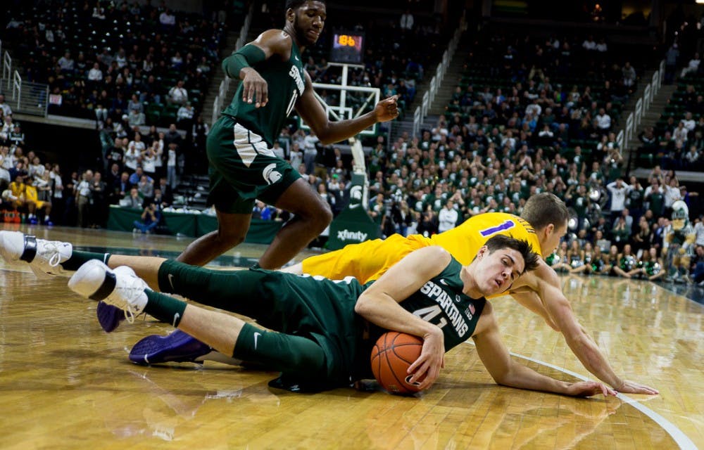 Redshirt junior guard Conner George (41) hangs onto the ball during the game against Tenessee Tech on Nov. 18, 2018 at the Breslin Center. The Spartans beat the Golden Eagles, 101-33.