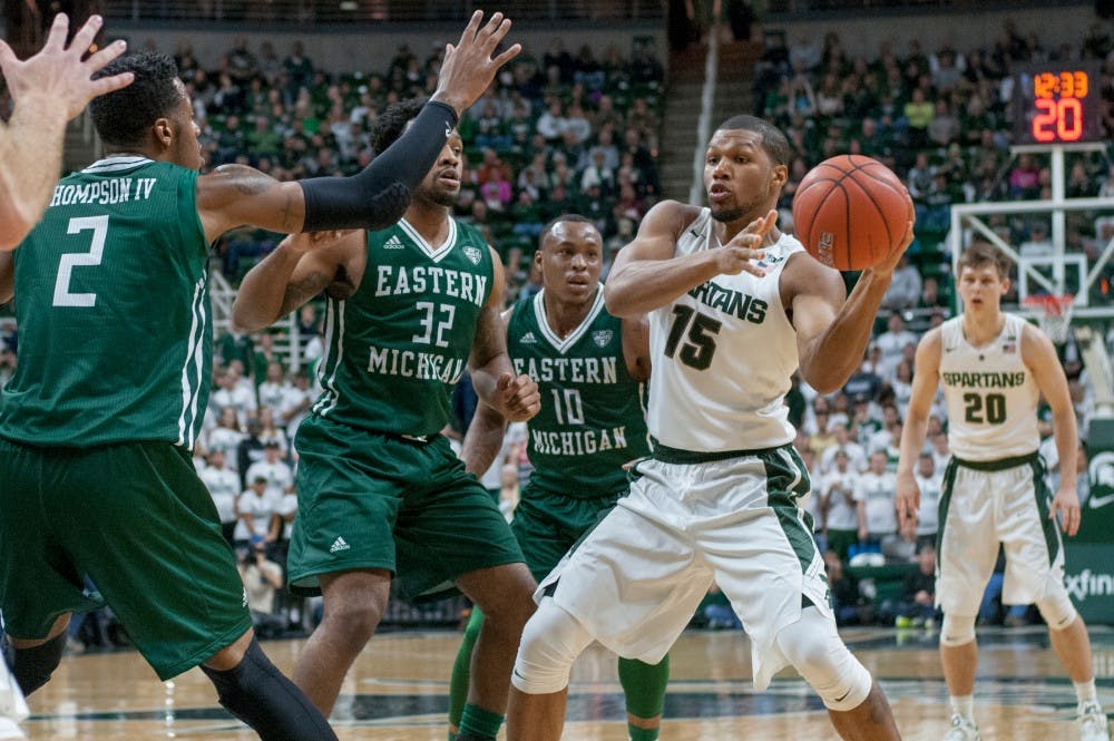 Sophomore forward Marvin Clark Jr. looks to pass the ball as Eastern Michigan center James Thompson IV, 2, Eastern Michigan guard Ty Toney, 32, and Eastern Michigan guard Willie Mangum IV, 10, defend during the first half of the game against Eastern Michigan on Nov. 23, 2015 at Breslin Center. The Spartans defeated the Eagles, 89-65.