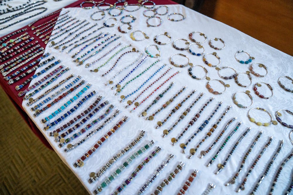Handmade magnetic jewelry made by Estelle and Robert Williams sits displayed at their vendor table during Michigan State’s annual winter arts and craft show at the Union on campus in East Lansing, Mich., on Saturday, Dec. 6, 2025.