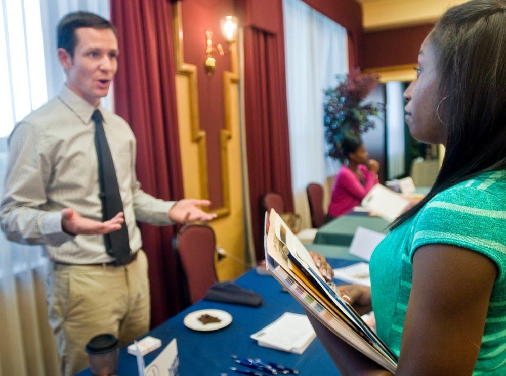 Social relations and policy junior Lilian Tripp networks with University of Pittsburgh graduate Kevin Tucker on Tuesday during the Law School Fair at the Union. The event hosted an array of over 100 law schools to give students an opportunity to learn about potential paths for their futures. Mo Hnatiuk/The State News