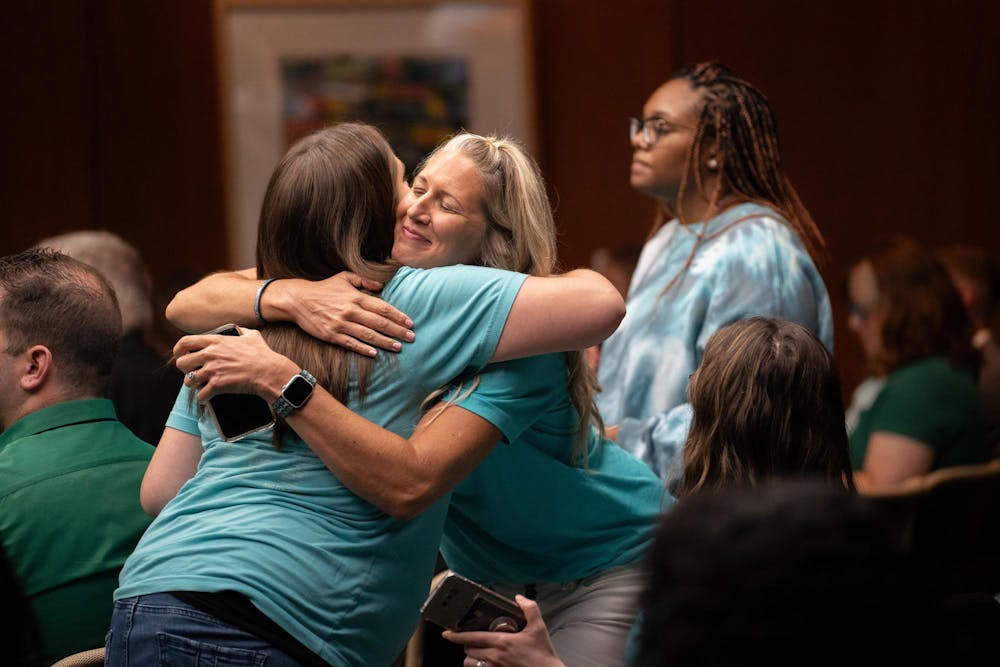 Sister Survivors hugging each after speaking at the Board of Trustees Meeting at the Hannah Administration Meeting on Sep. 8, 2023.