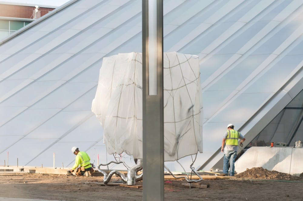 Construction workers near completion on the Eli and Edythe Broad Art Museum on Wednesday, Sept. 12, 2012. The museum is slated for completion on Nov. 9, 2012. Julia Nagy/The State News