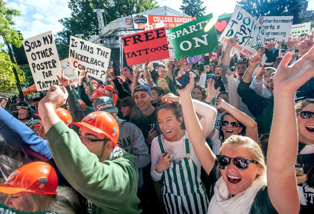	<p>Fans cheer into the camera during a live <span class="caps">ESPN</span> College GameDay broadcast on Saturday, Sept. 29, 2012 near Beaumont Tower. Hundreds of fans brought their homemade signs to the show, which previewed the day&#8217;s college football games, including the match between <span class="caps">MSU</span> and Ohio State scheduled Saturday afternoon. Justin Wan/The State News</p>
