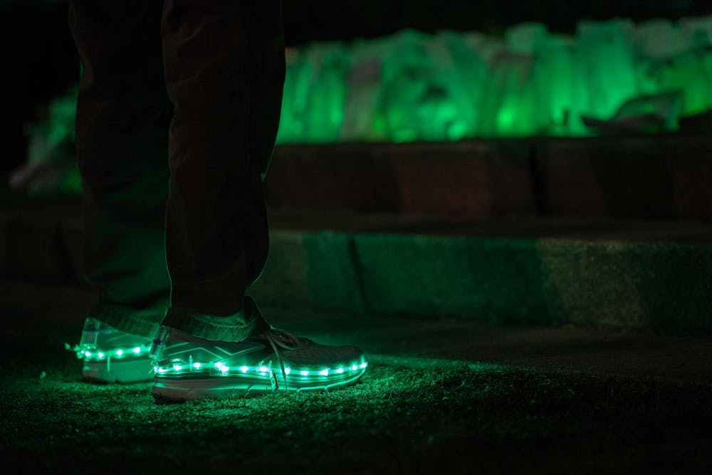 <p>An MSU community member stands in front of the Spartan Statue with green-lit shoes on Feb. 13, 2024. One year after the Michigan State University campus shooting, a remembrance ceremony was held to remember and reflect on the tragedy.</p>