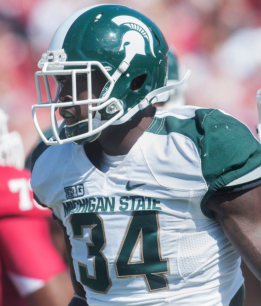 	<p>Sophomore linebacker Taiwan Jones walks off the field after a play Saturday, Oct. 6, 2012, at Memorial Stadium in Bloomington, Ind. Despite defensive struggles in the first half, the Spartans were able to defeat Indiana University 31-27. Adam Toolin/The State News</p>