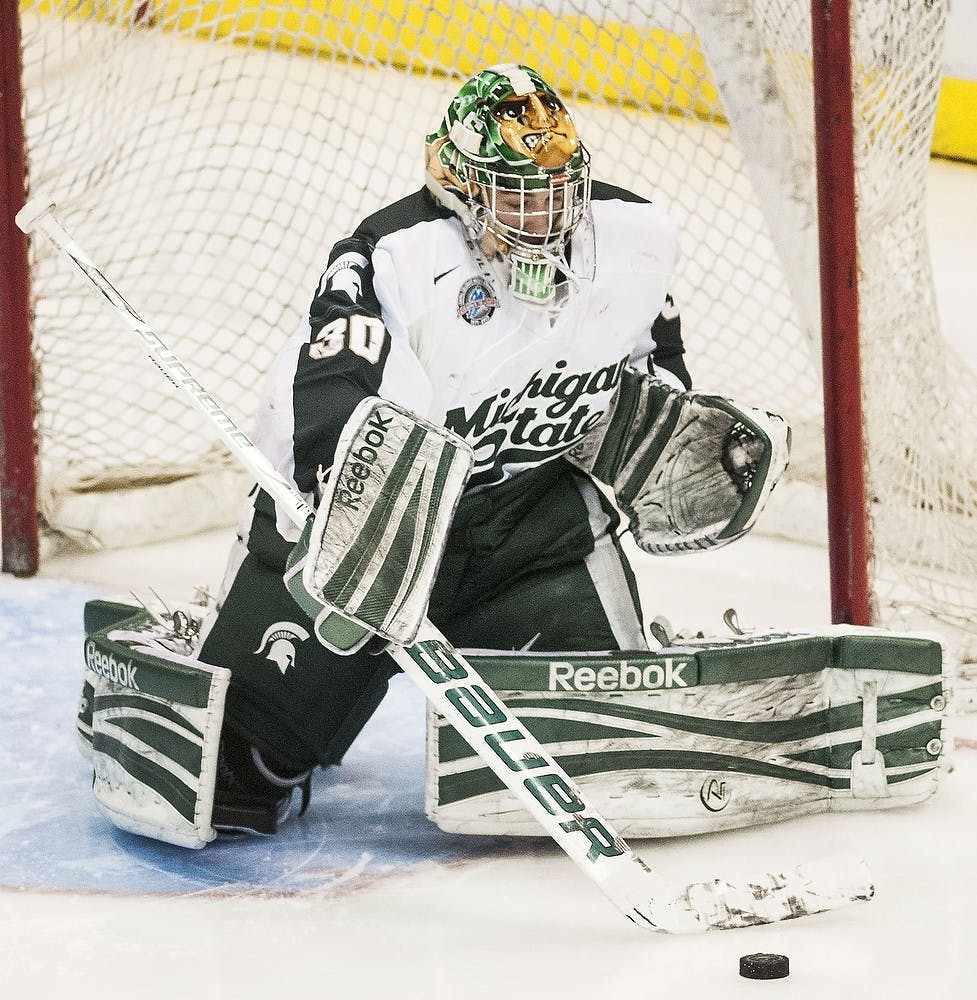 	<p>Freshman goaltender Jake Hildebrand extends his stick to make a save Saturday, Feb. 2, 2013, at Joe Louis Arena in Detroit. The Wolverines defeated the Spartans, 5-2, in the second game of the weekend series. Adam Toolin/The State News</p>