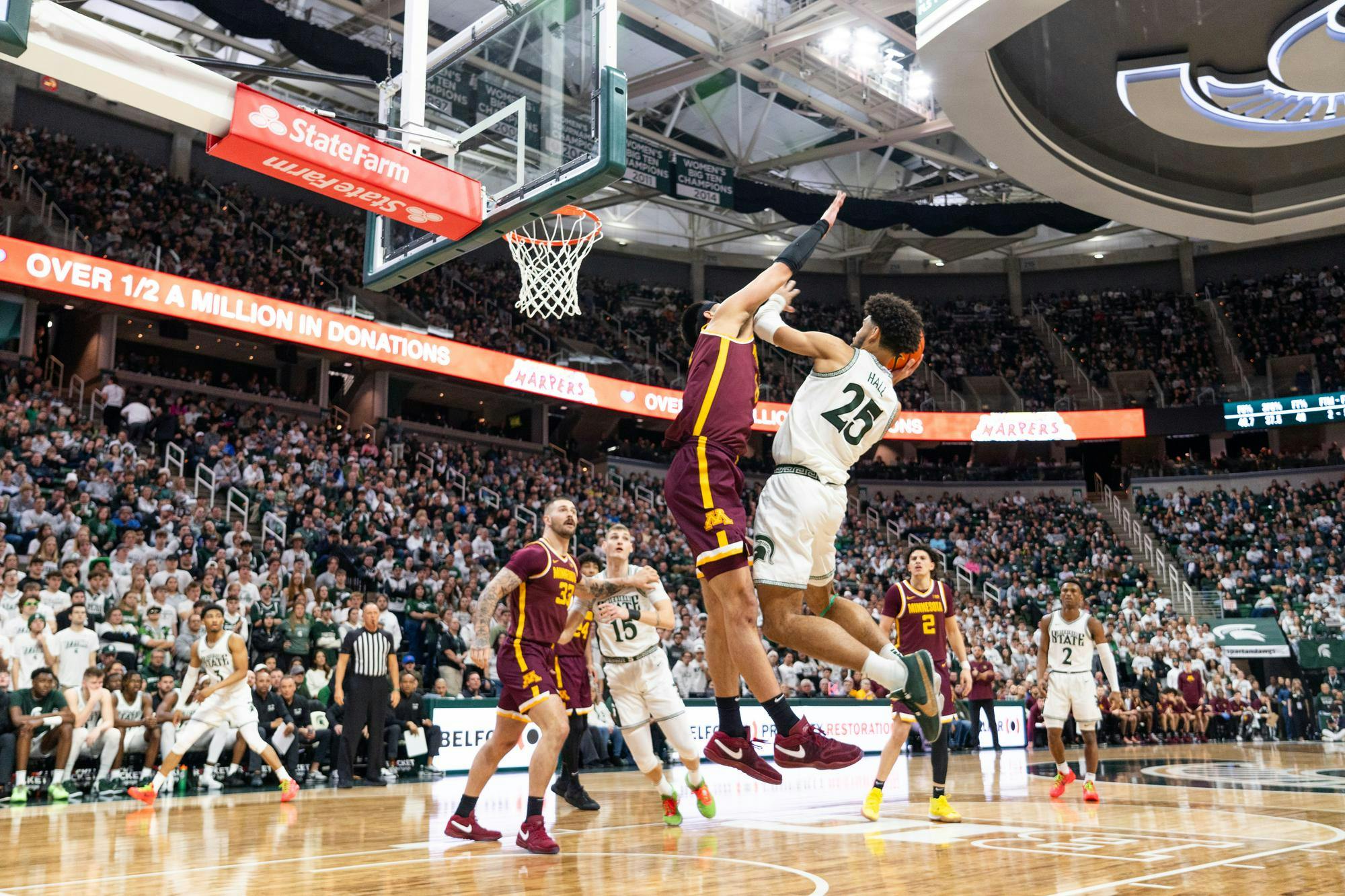 <p>MSU forward Malik Hall (25) attempts to score over University of Minnesota players at the Breslin Center in East Lansing on Thursday, Jan. 18, 2024. </p>