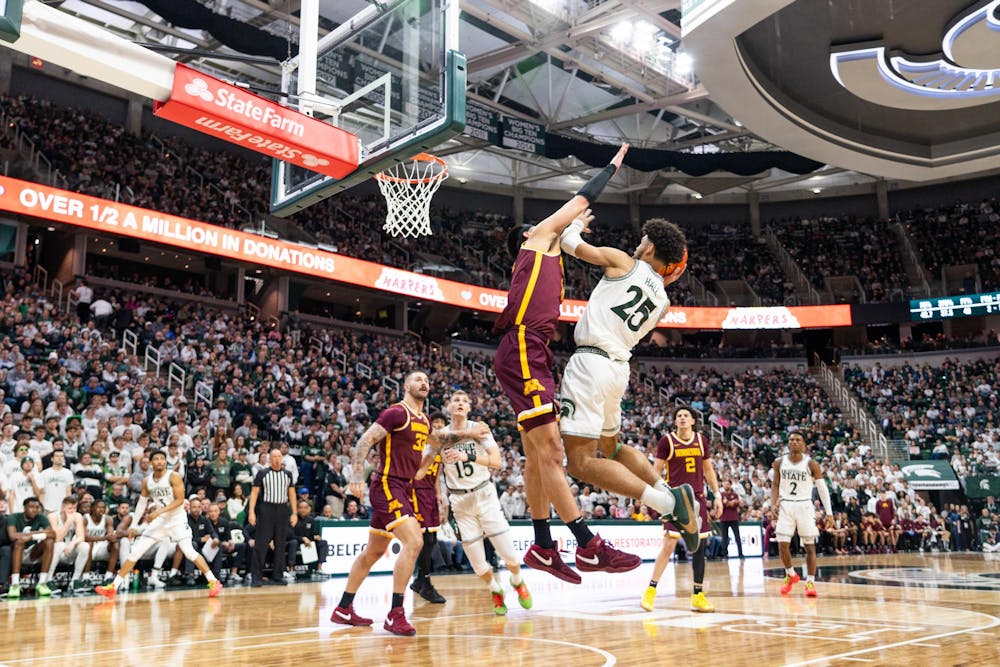 <p>MSU forward Malik Hall (25) attempts to score over University of Minnesota players at the Breslin Center in East Lansing on Thursday, Jan. 18, 2024. </p>