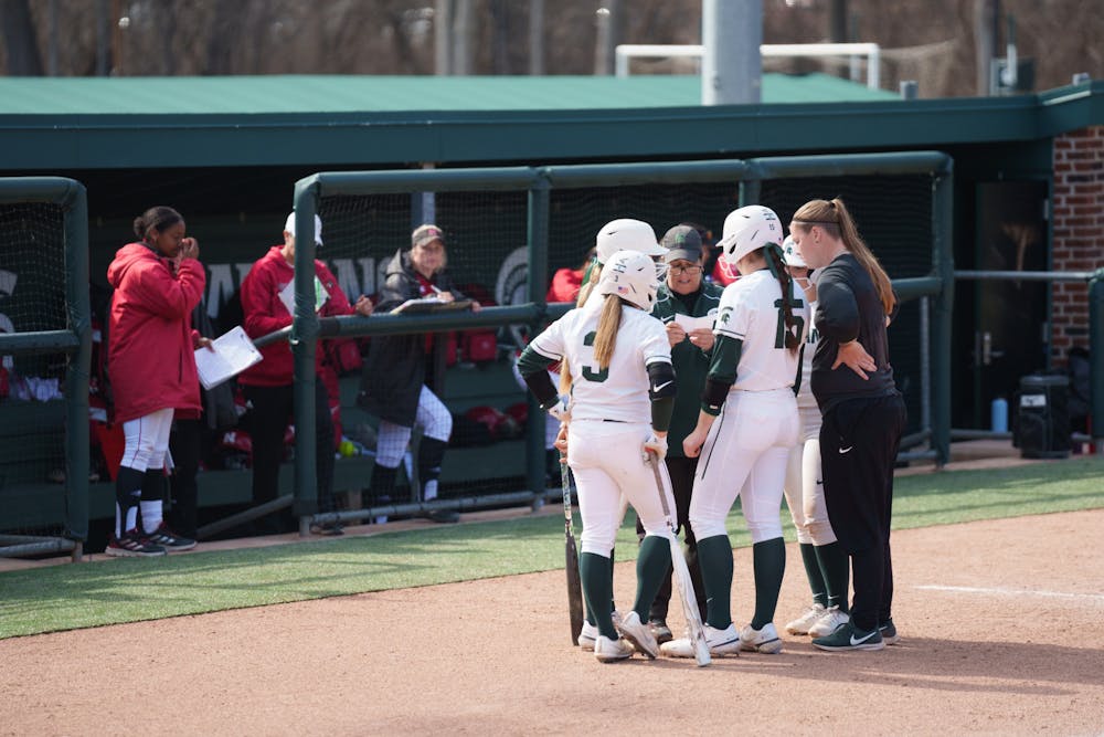 <p>Michigan State softball head coach Jacquie Joseph talking with everyone who is batting or currently on a base in the middle of the inning. Spartans lost 5-4 against Nebraska, on April 10, 2022.</p>