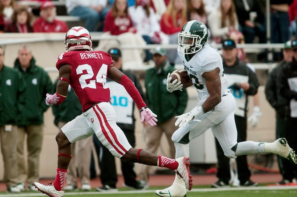 <p>Senior running back Jeremy Langford charges past Indiana cornerback Tim Bennett towards the end zone during the game against Indiana on Oct. 18, 2014, at Memorial Stadium in Bloomington, Ind. The Spartans defeated the Hoosiers, 56-17. Raymond Williams/The State News</p>