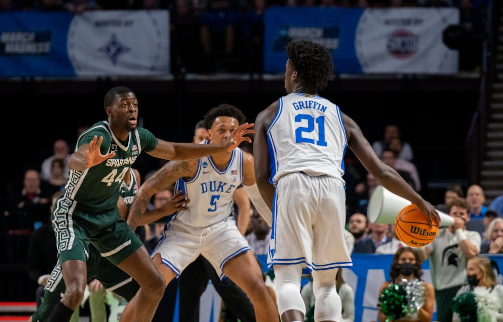 <p>Senior forward Gabe Brown (44) defends against freshman forward AJ Griffin (21) during Duke&#x27;s victory over Michigan State on March 20, 2022.</p>