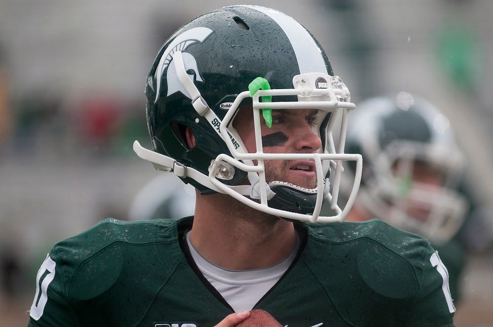 	<p>Senior quarterback Andrew Maxwell warms up with the team before the game against Michigan on Nov. 2, 2013, at Spartan Stadium. <span class="caps">MSU</span> defeated the Wolverines, 29-6. Danyelle Morrow/The State News</p>