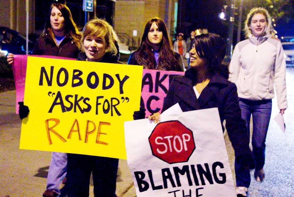 From Left, English education junior Amy Baditoi and psychology junior Preethi Bandri march down Grand River Ave. during Take Back the Night March Tuesday night on Grand River Ave. Take Back the Night spreads awareness about sexual assault. Aaron Snyder/The State News