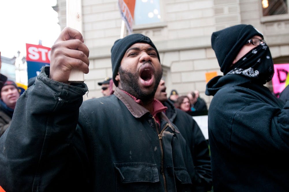 	<p>Lansing resident William Stuckey chants Tuesday, Dec. 11, 2012, at the Capitol during the protest rally against the right-to-work legislation. Stuckey is a member of the local 1098 Union. Katie Stiefel/ The State News</p>