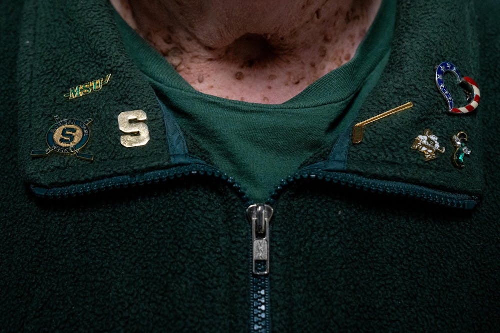 <p>Shery Gieger, 76, of Lansing, shows her Michigan State hockey pin collection during a game between Michigan State and Wisconsin at Munn Ice Arena in East Lansing, Mich., on Saturday, Nov. 22, 2025.</p>