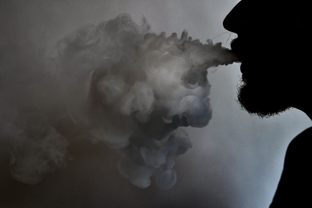 <p>After taking a hit of their vape, a student exhales a cloud of the flavored nicotine liquid — soon to be banned.</p>