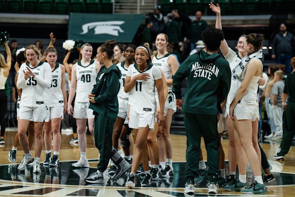 The women’s basketball team celebrates after earning a hard-fought win against DePaul University at the Breslin Center on Dec. 8, 2024. The Spartans won 89-61 against the Blue Demons, starting the season 9-0 for the first time in program history. 