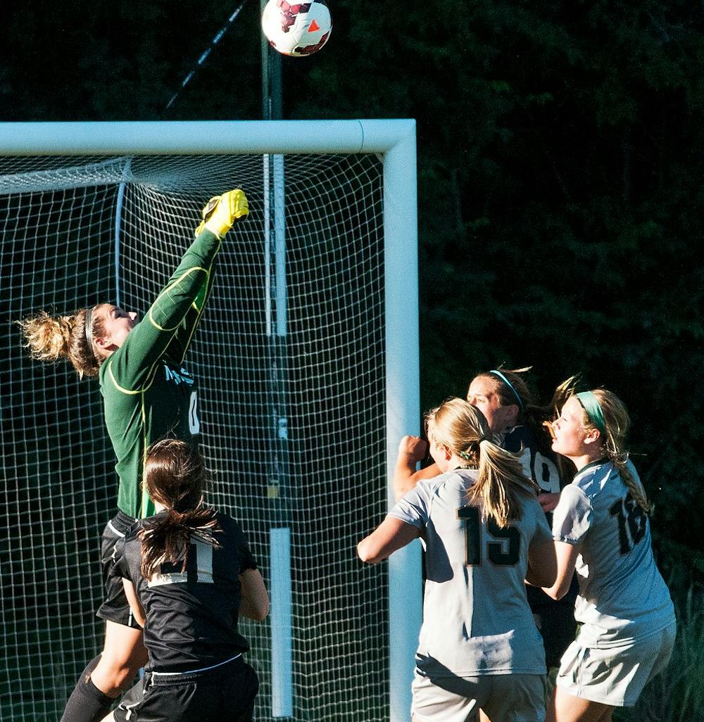 	<p>Junior goalkeeper Courtney Clem jumps to save the ball during the match against Oakland Sept. 5, 2013 at DeMartin Stadium. The Spartans tied the Grizzlies, 1-1, after playing two scoreless overtime periods. Khoa Nguyen/ The State News</p>