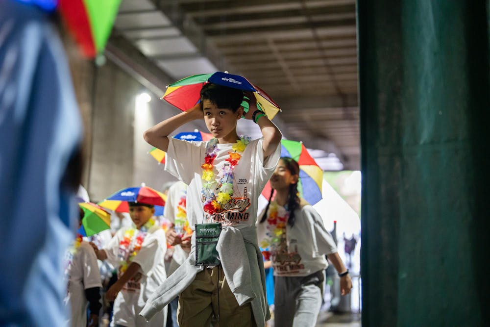 Odyssey of the Minds competitors enter the Jack Breslin Student Events Center prior to the opening ceremony in East Lansing, Michigan on May 21, 2025. The OOTM opening ceremony featured a parade of attendees, t-shirt cannons, dancing, and speeches. 