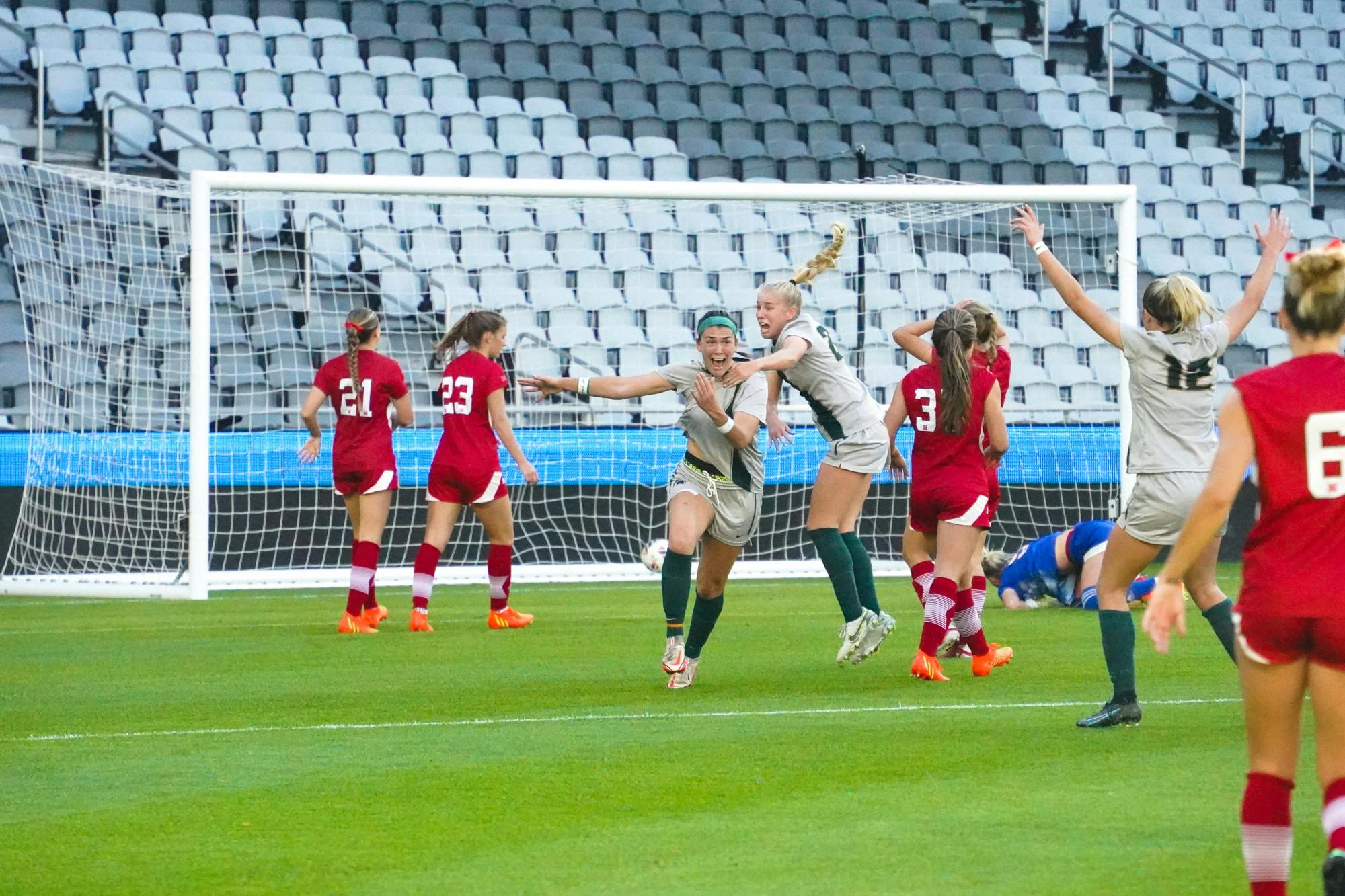 <p>Graduate forward Camryn Evans scores the first goal of the game and celebrates with freshman midfielder Courtney Koehler. Photo by Ethan Hunter.</p>