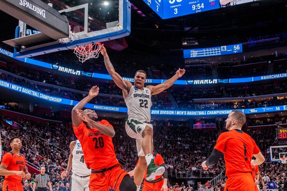 <p>Sophomore guard Miles Bridges (22) dunks the ball during the first round of the NCAA tournament against Bucknell on March 16, 2018 at Little Caesars Arena in Detroit. The Spartans defeated the Bison 82-78.</p>