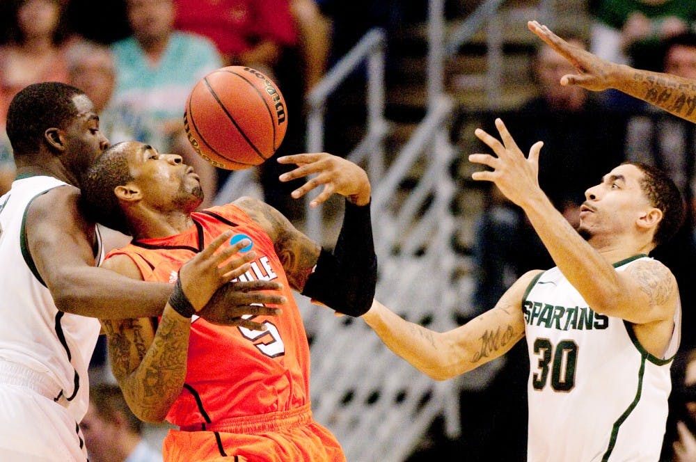 Louisville guard Chris Smith fumbles for possesion Thursday night at US Airways Center in Pheonix, Az. The Cardinals defeated the Spartans, knocking them out of the NCAA tournament, 57-44. Matt Hallowell/The State News