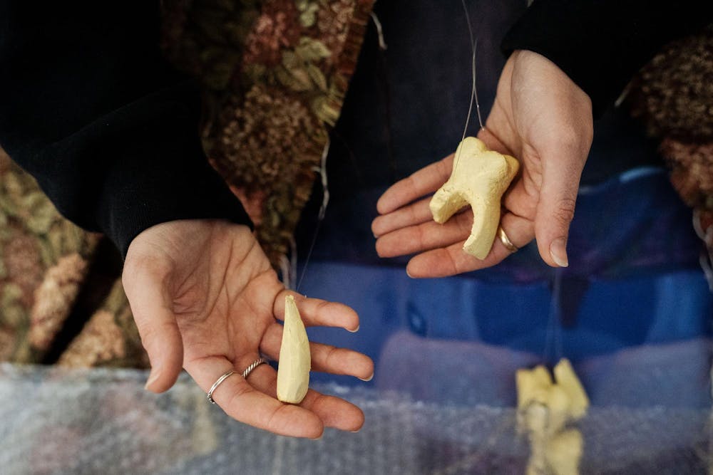 
Fourth-year Michigan State studio art student Evan Yalowitz explains one of her pieces in her room on April 13, 2025. The work is based on a recurring dream in which she loses all of her teeth. “I have had that dream about 20 times, I think,” Yalowitz said.