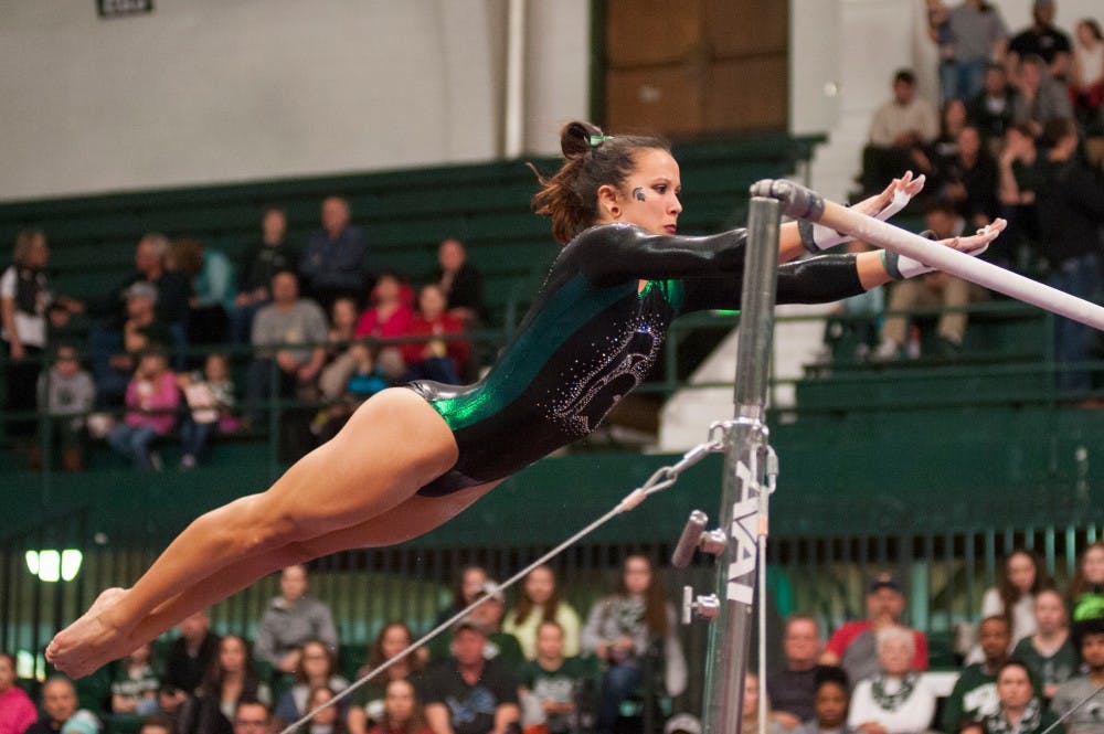 Freshman Drew Hendershot  preforms on the bars during the  MSU womens gymnastic's meet against Illinois on Feb. 19, 2016 at Jenison Field House.