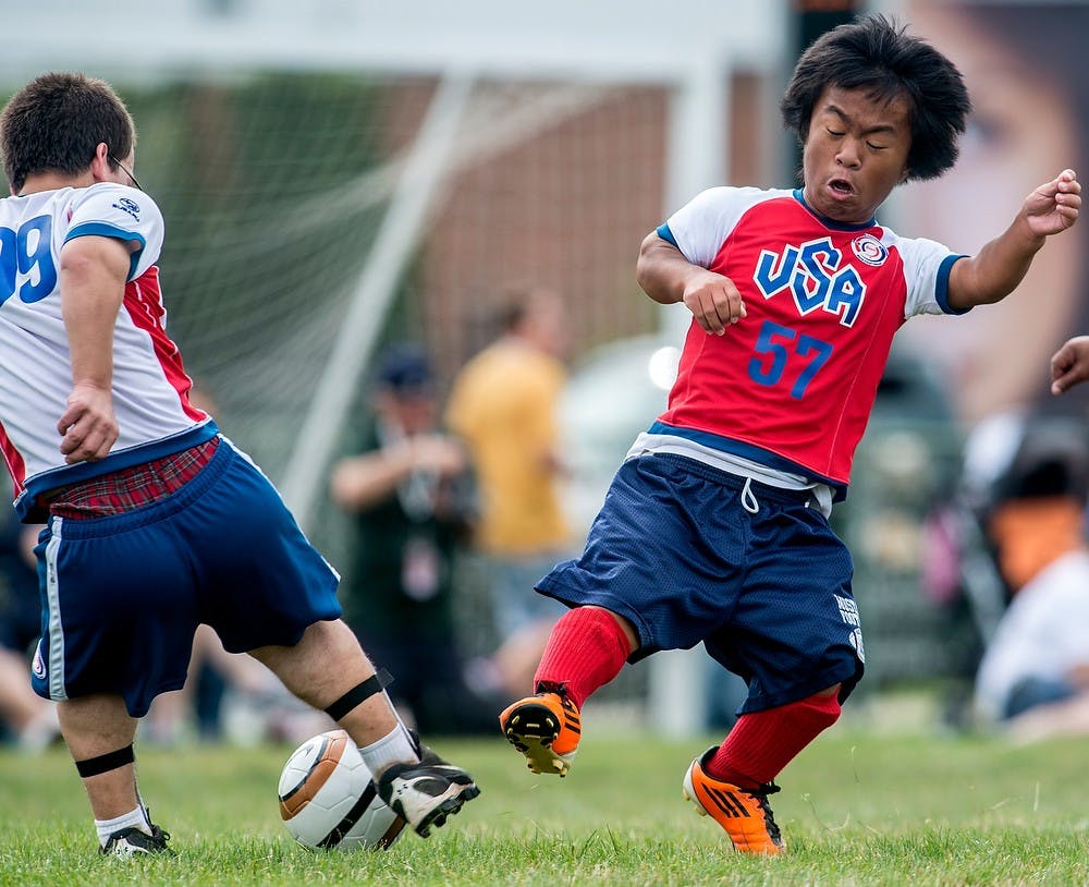	<p>Houston resident Will Roch, 17, right, battles the ball with Commack, N.Y. resident Teddy Tilkin, Aug. 5, 2013, at Munn Field during the 2013 World Dwarf Games. Soccer and shooting dominated the schedule for Monday. Justin Wan/The State News</p>