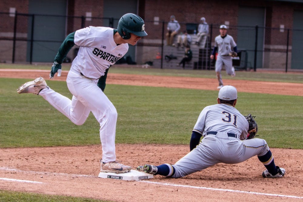<p>Notre Dame first baseman Daniel Jung (31) stretches for a throw to retire sophomore outfielder Bryce Kelley (17) during the game against Notre Dame on April 10, 2018 at McLane Baseball Stadium. The Spartans fell to the Fighting Irish, 8-7.</p>