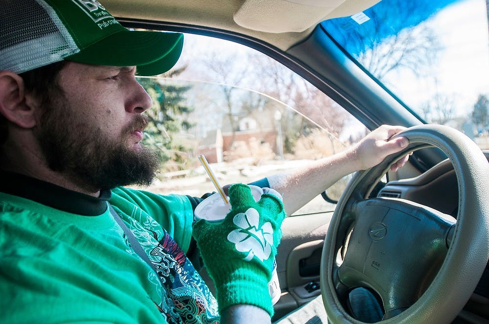 <p>Lansing resident and cab driver James Wandell drives to pick up a "regular" March, 17, 2014, in his cab car. Although St. Patrick's Day was on a Monday, Wandell had many MSU student customers call him to get rides to parties. Erin Hampton/The State News</p>
