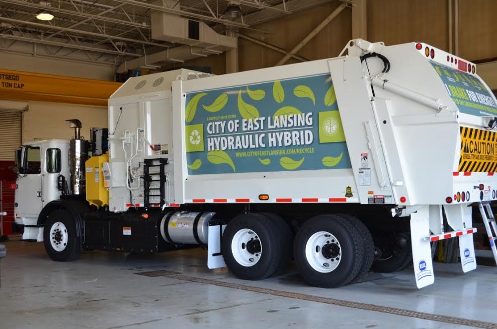 <p>The city of East Lansing's new recycling truck sits in its garage. The truck is a fully automated hydraulic hybrid. It is expected to consume 35-50 percent less fuel than a standard recycling truck.</p>
