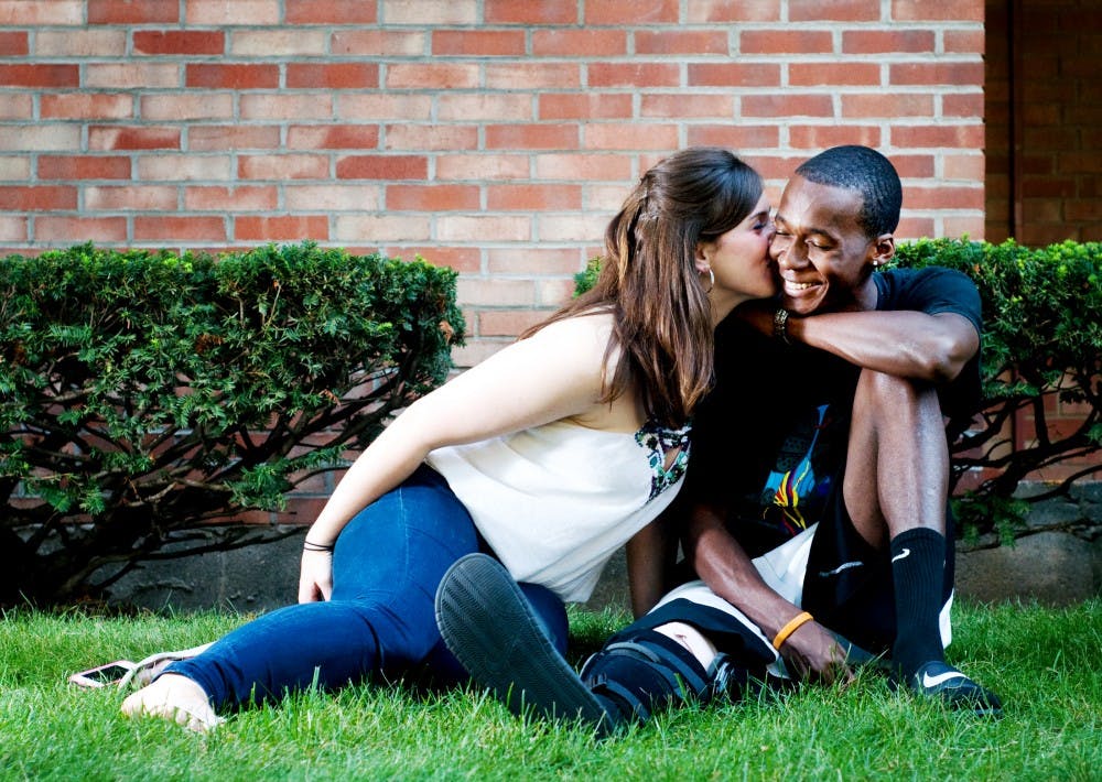 Journalism and social relations and policy senior Kayla Roney and psychology senior Kris Amos have been together since they met in Aug. 2010. Roney and Amos are amongst a growing number of interracial couples across the country. Matt Radick/The State News