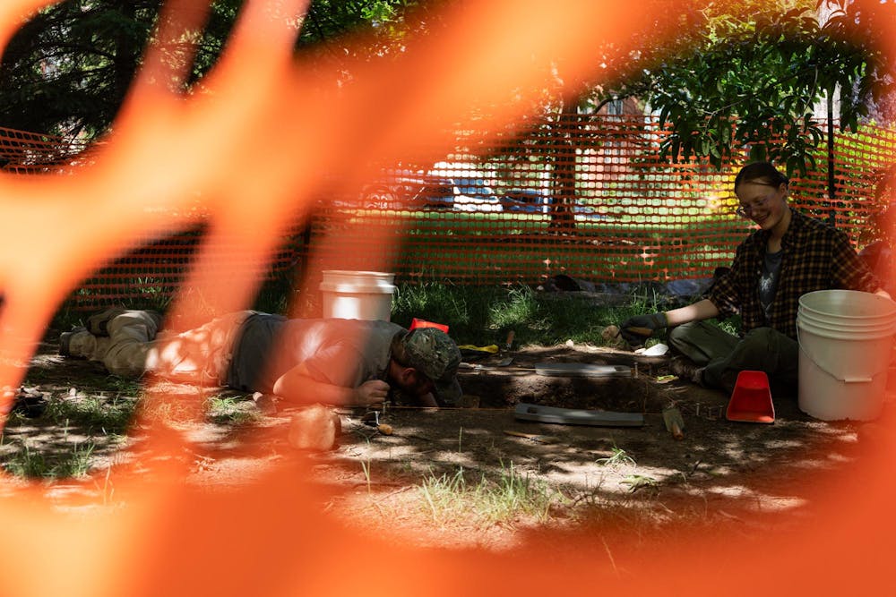 <p>Members of the Campus Archaeology Program, PhD student Andrew McKinney and undergraduate student Deanna Peterson (left to right), work on the old observatory site in East Lansing, Mich., on June 15, 2026.</p>