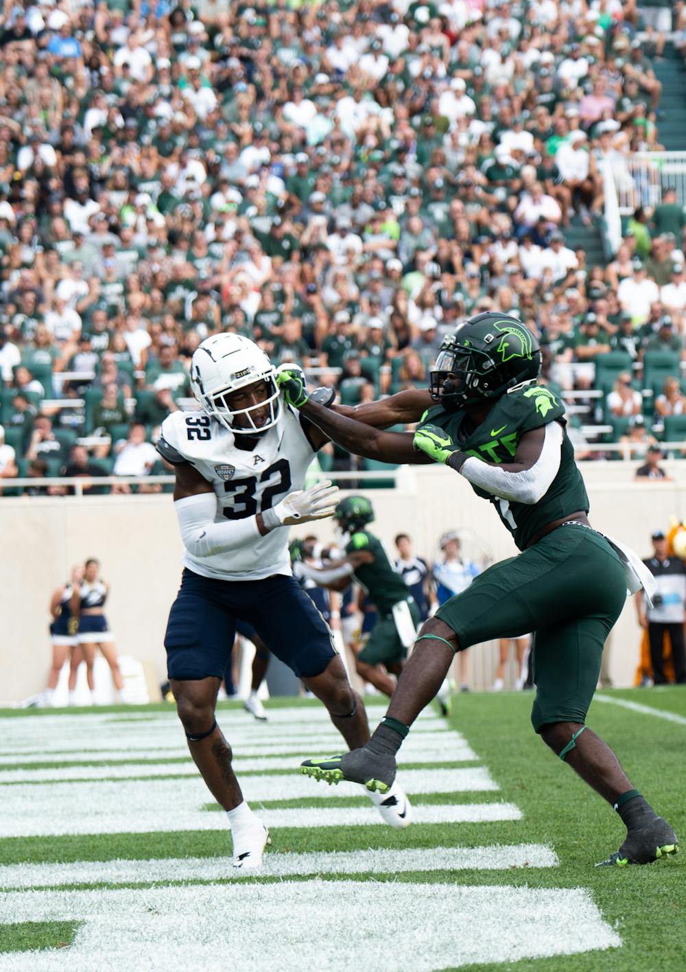 Freshman safety Jaden Mangham (1) blocks Akron freshman running back Anthony Stallworth (32) during a game at Spartan Stadium on Sept. 10, 2022. The Spartans beat the Zips with a score of 52-0.