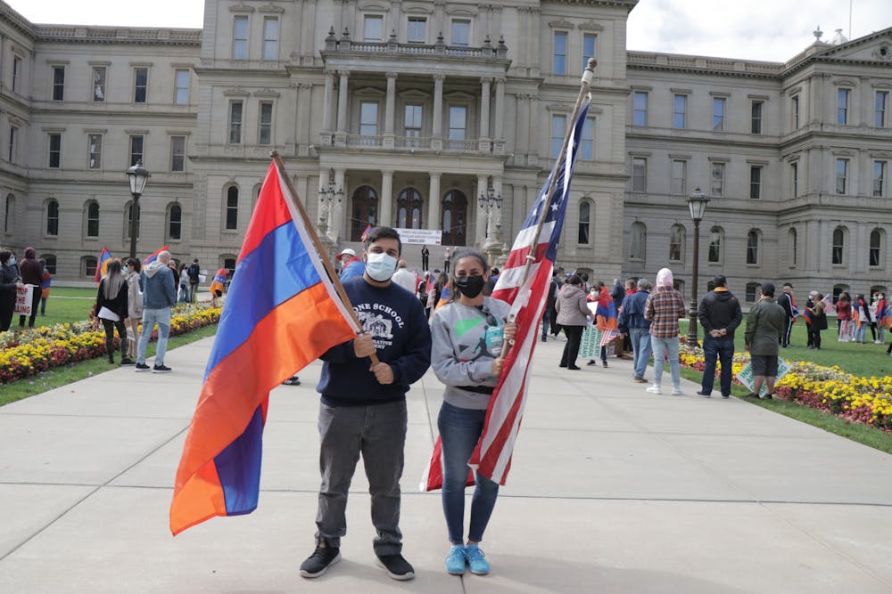 <p>East Lansing Mayor Aaron Stephens and Michigan State Rep. Mari Manoogian stand in support of Armenia at the Capitol on Oct. 11, 2020.</p>