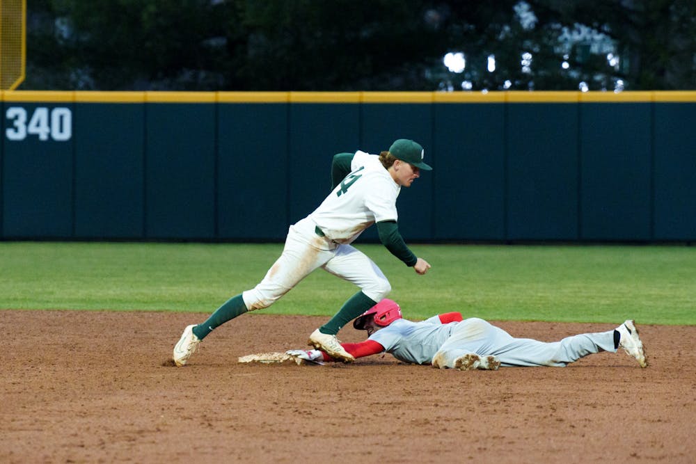 <p>Michigan State sophomore Mitch Jebb casing the ball after Youngtown State senior Lucas Nasonti slides into second, on March 30, 2022. Spartans are victorious 12-5 against Youngtown State.</p>