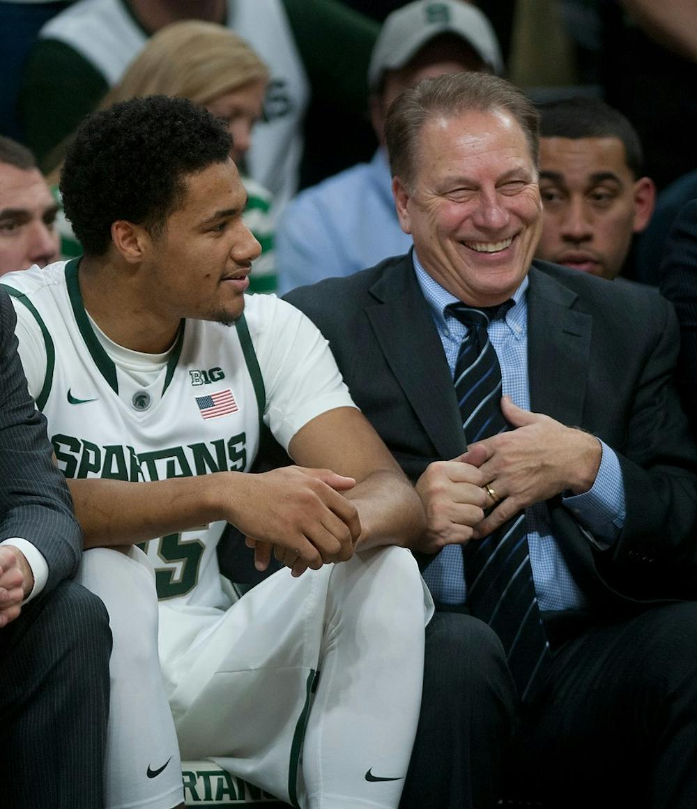 <p>Head coach Tom Izzo shares a laugh with freshman forward Kenny Goins during the game against Loyal University on Nov. 21, 2014, at Breslin Center. The Spartans defeated the Ramblers 87-52. Raymond Williams/The State News</p>