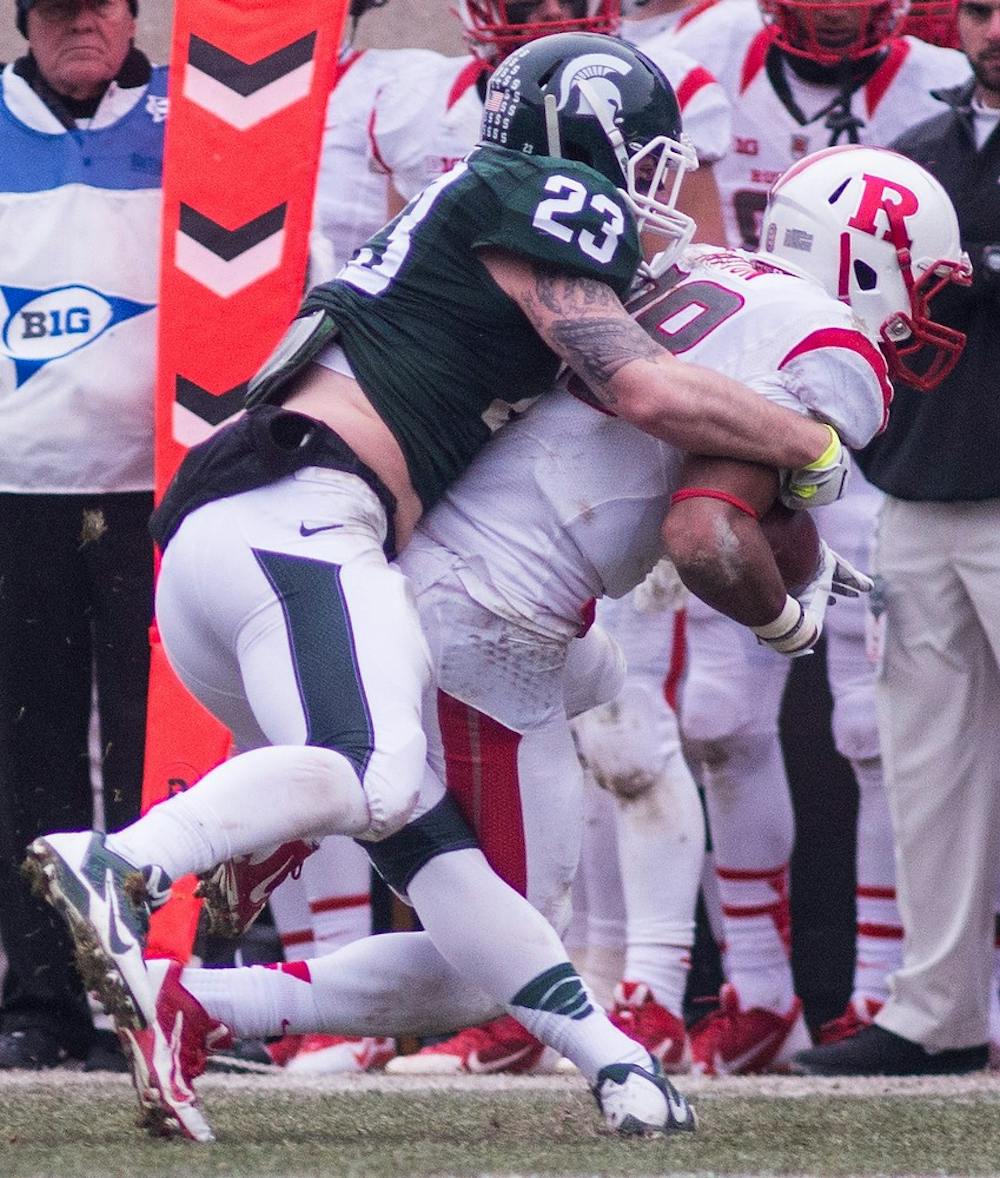 <p>Then freshman linebacker Chris Frey tackles Rutgers wide receiver Andre Patton Nov. 22, 2014, during the game at Spartan Stadium. The Spartans defeated the Scarlet Knights, 45-3. Erin Hampton/The State News</p>