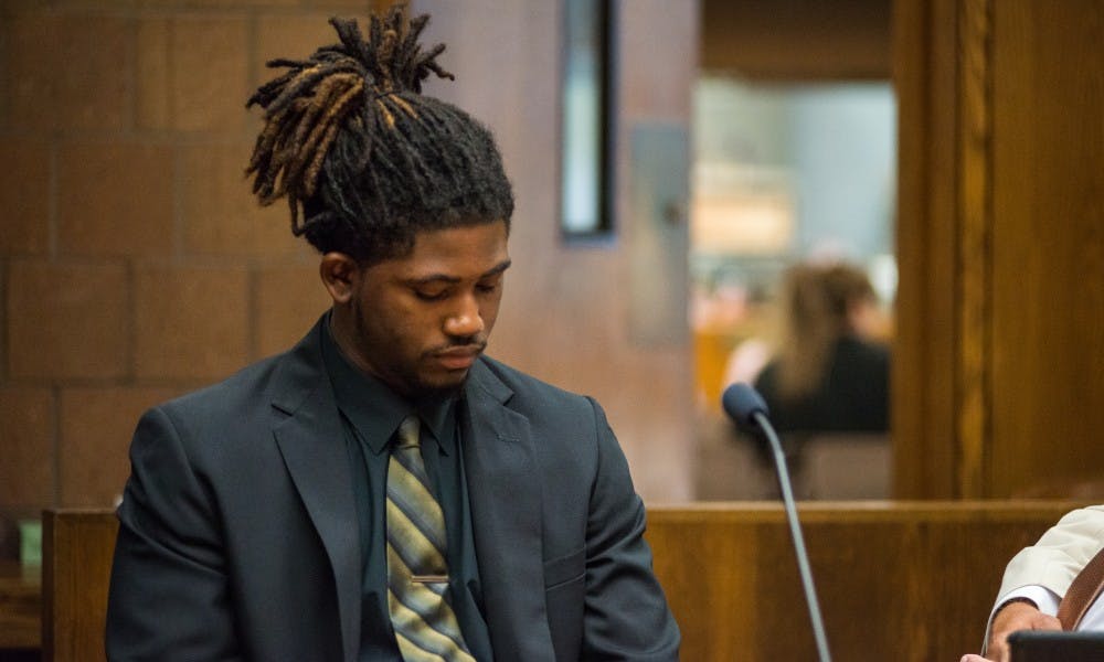 <p>Former MSU football player Auston Roberston looks to the ground on June 22, 2017, at the 55th District Court in Mason, Michigan. At the hearing Judge Thomas P. Boyd ordered an additional count of third-degree criminal sexual conduct be charged against Robertson for his alleged role in a sexual assault in April.</p>
