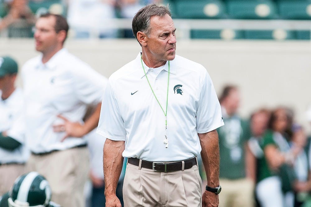 <p>Head coach Mark Dantonio watches on as his team prepares for the start of the game on Sept. 7, 2013. The Spartans topped the Bulls, 21-6. Khoa Nguyen/ The State News</p>