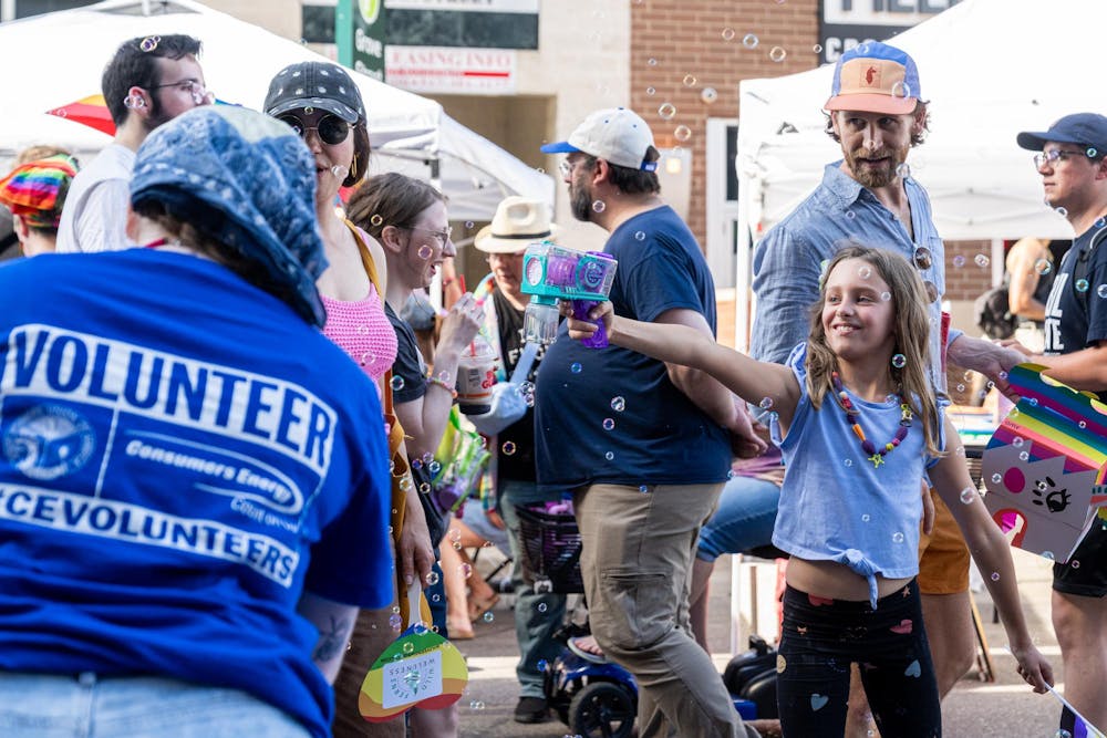 <p>A young kid sprays bubbles back at volunteers who started spraying bubbles at her during East Lansing Pride in East Lansing, Mich., on June 13, 2026.</p>